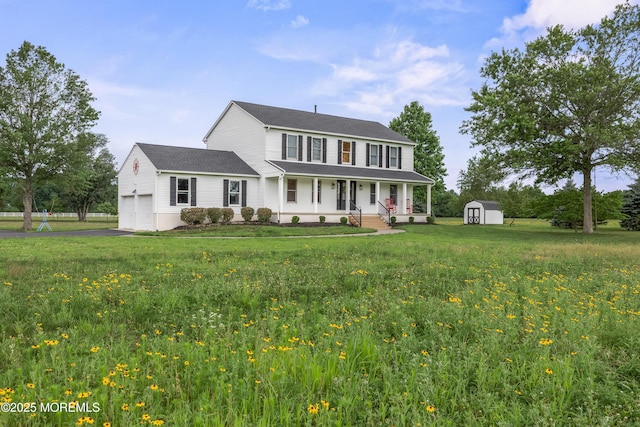 69 Eayrestown Rd, Medford, NJ 08055 - view of front of property featuring covered porch, a storage unit, a garage, asphalt driveway, and a front yard