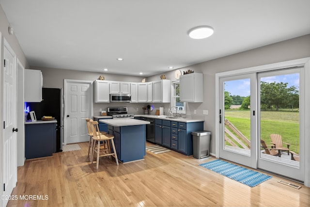 69 Eayrestown Rd, Medford, NJ 08055 - kitchen featuring stainless steel appliances, blue cabinetry, a center island, a kitchen bar, and light countertops