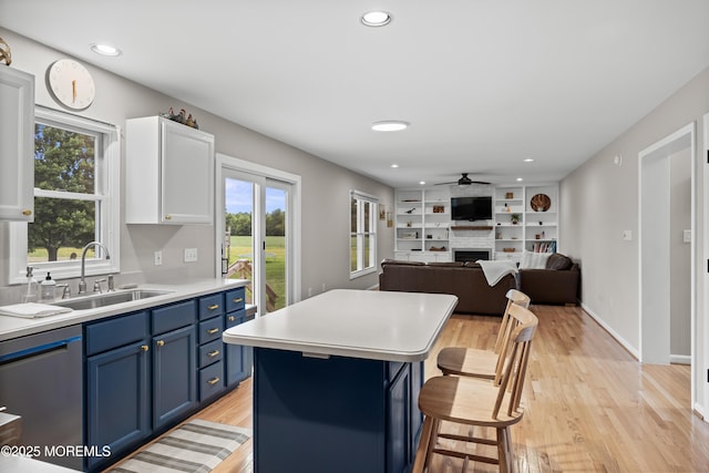 69 Eayrestown Rd, Medford, NJ 08055 - kitchen with blue cabinetry, dishwasher, a breakfast bar, a ceiling fan, and plenty of natural light