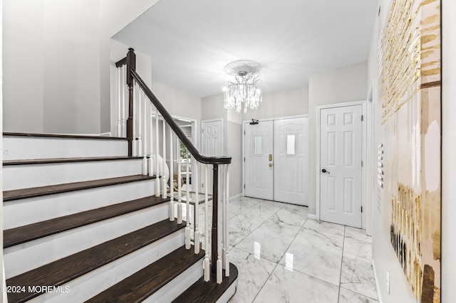 1501 Pine Park Ave, Lakewood, NJ 08701 - entryway with a chandelier, stairs, marble look tile flooring, and baseboards