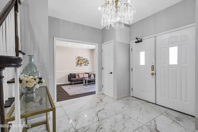 1501 Pine Park Ave, Lakewood, NJ 08701 - entryway with marble finish floors, a chandelier, and baseboards
