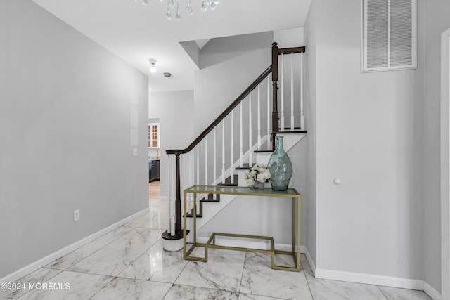 1501 Pine Park Ave, Lakewood, NJ 08701 - staircase with marble finish flooring, baseboards, and a chandelier