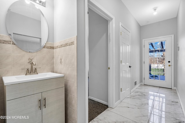 1501 Pine Park Ave, Lakewood, NJ 08701 - bathroom featuring marble finish flooring, vanity, tile walls, and baseboards