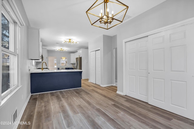 1501 Pine Park Ave, Lakewood, NJ 08701 - kitchen featuring a chandelier, white cabinets, light countertops, a sink, and a peninsula