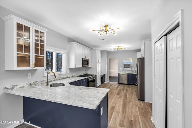 1501 Pine Park Ave, Lakewood, NJ 08701 - kitchen with a sink, stainless steel appliances, a chandelier, a peninsula, and light wood finished floors
