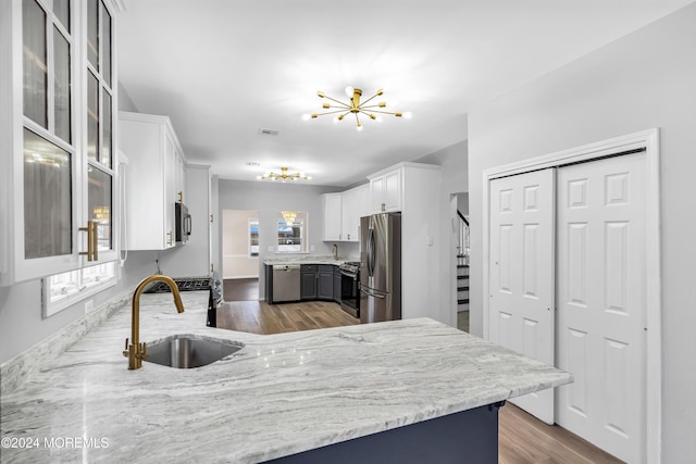 1501 Pine Park Ave, Lakewood, NJ 08701 - kitchen with appliances with stainless steel finishes, a sink, a chandelier, dark wood finished floors, and white cabinetry