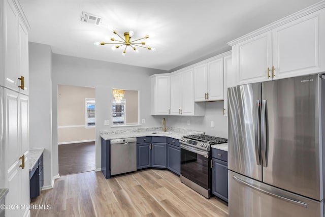 1501 Pine Park Ave, Lakewood, NJ 08701 - kitchen featuring stainless steel appliances, a chandelier, and white cabinets