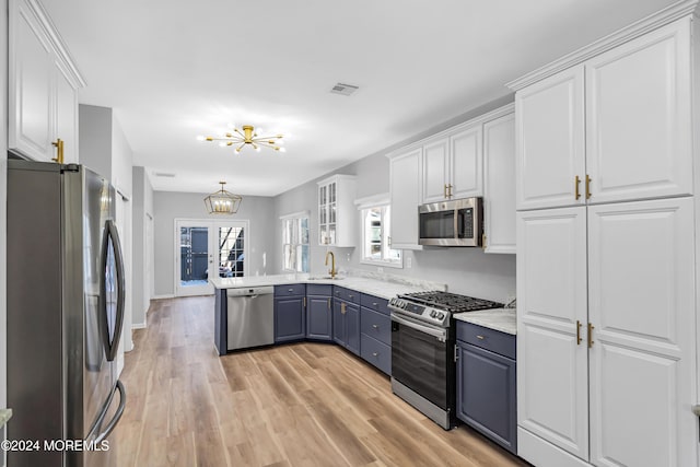 1501 Pine Park Ave, Lakewood, NJ 08701 - kitchen featuring stainless steel appliances, blue cabinetry, a sink, and white cabinets