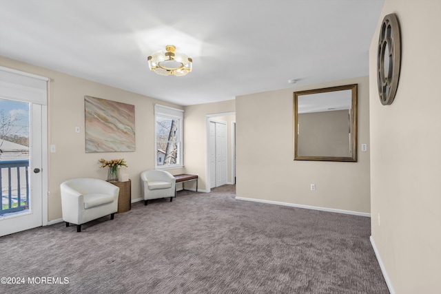 1501 Pine Park Ave, Lakewood, NJ 08701 - living area featuring carpet flooring, baseboards, and a chandelier