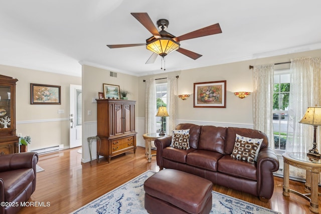 10 Weybridge Pl, Manchester, NJ 08759 - living room with baseboard heating, wood finished floors, ceiling fan, healthy amount of natural light, and crown molding