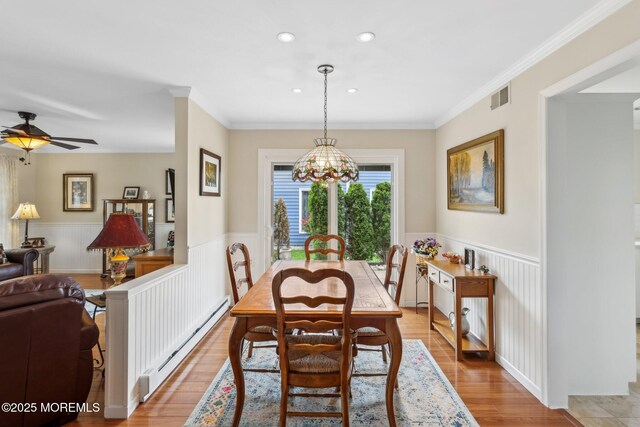 10 Weybridge Pl, Manchester, NJ 08759 - dining area featuring baseboard heating, wainscoting, light wood-style floors, recessed lighting, and ornamental molding