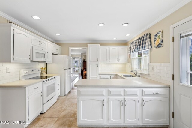 10 Weybridge Pl, Manchester, NJ 08759 - kitchen featuring white appliances, a sink, white cabinetry, a peninsula, and decorative backsplash