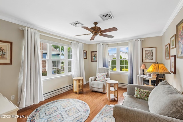10 Weybridge Pl, Manchester, NJ 08759 - sitting room with a baseboard heating unit, ceiling fan, ornamental molding, and wood finished floors