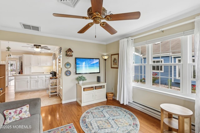 10 Weybridge Pl, Manchester, NJ 08759 - living room with ceiling fan, light wood-type flooring, crown molding, baseboards, and a baseboard heating unit