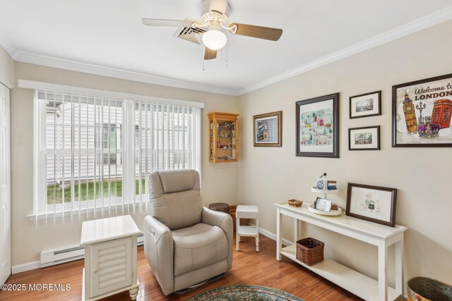 10 Weybridge Pl, Manchester, NJ 08759 - living area featuring a baseboard heating unit, crown molding, ceiling fan, wood finished floors, and baseboards