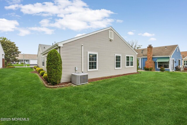 10 Weybridge Pl, Manchester, NJ 08759 - back of house with cooling unit and a lawn