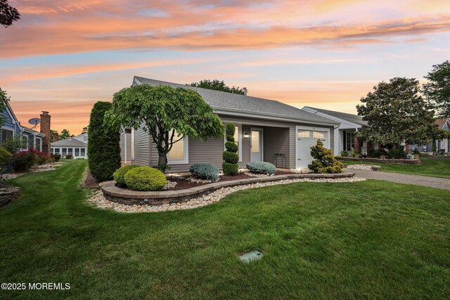 10 Weybridge Pl, Manchester, NJ 08759 - view of front of property featuring a garage, driveway, a yard, and a shingled roof