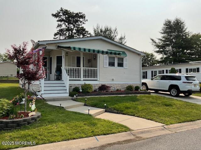 37 Pine Ridge Blvd, Whiting, NJ 08759 - view of front of home with a porch and a front lawn