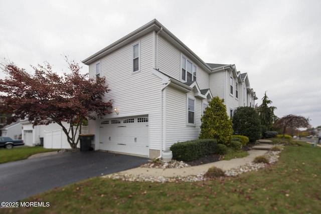 22 Enclosure Dr, Morganville, NJ 07751 - view of side of home featuring an attached garage and driveway
