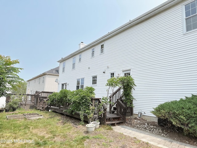 22 Enclosure Dr, Morganville, NJ 07751 - rear view of property featuring a wooden deck and a chimney