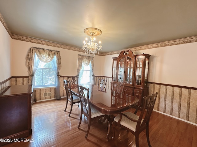 22 Enclosure Dr, Morganville, NJ 07751 - dining room featuring a chandelier, wainscoting, and hardwood / wood-style flooring