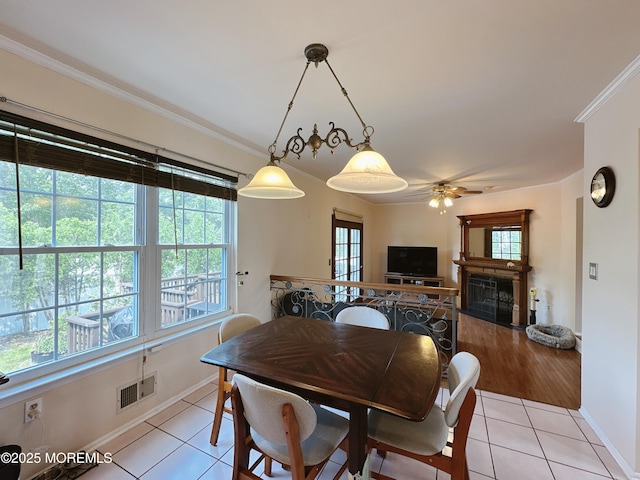 22 Enclosure Dr, Morganville, NJ 07751 - dining room featuring light tile patterned floors, ceiling fan, crown molding, and a fireplace
