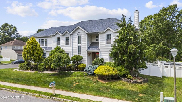 22 Enclosure Dr, Morganville, NJ 07751 - traditional-style home with a chimney and a shingled roof