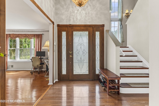 22 Enclosure Dr, Morganville, NJ 07751 - entrance foyer with hardwood / wood-style flooring, stairs, and a towering ceiling