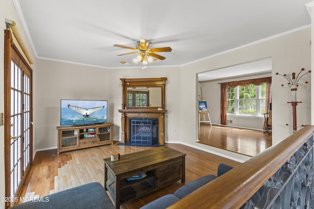 22 Enclosure Dr, Morganville, NJ 07751 - living area with a fireplace with flush hearth, wood finished floors, a ceiling fan, and crown molding