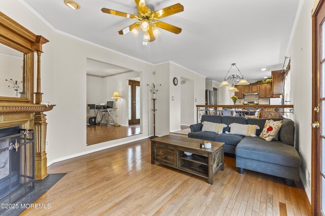 22 Enclosure Dr, Morganville, NJ 07751 - living room featuring a fireplace with flush hearth, light wood-type flooring, a ceiling fan, recessed lighting, and ornamental molding