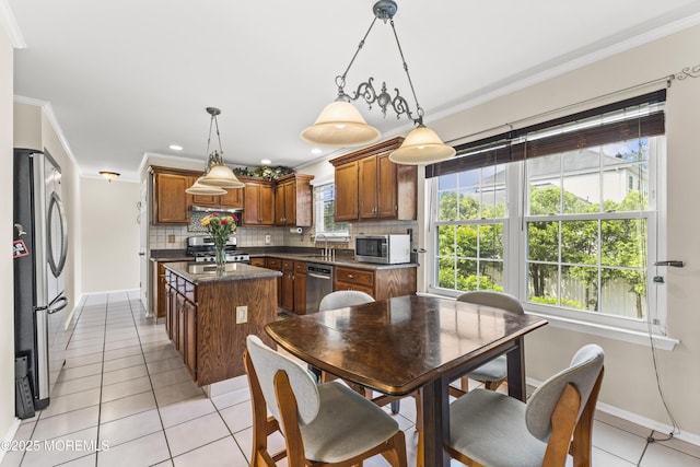 22 Enclosure Dr, Morganville, NJ 07751 - kitchen with appliances with stainless steel finishes, a kitchen island, dark countertops, crown molding, and light tile patterned floors