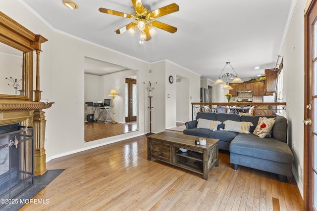 22 Enclosure Dr, Morganville, NJ 07751 - living room featuring a fireplace with flush hearth, light wood-type flooring, a ceiling fan, recessed lighting, and ornamental molding