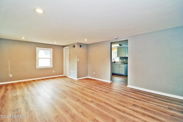 503 Center St, Forked River, NJ 08731 - spare room featuring light wood finished floors, baseboards, recessed lighting, and a sink
