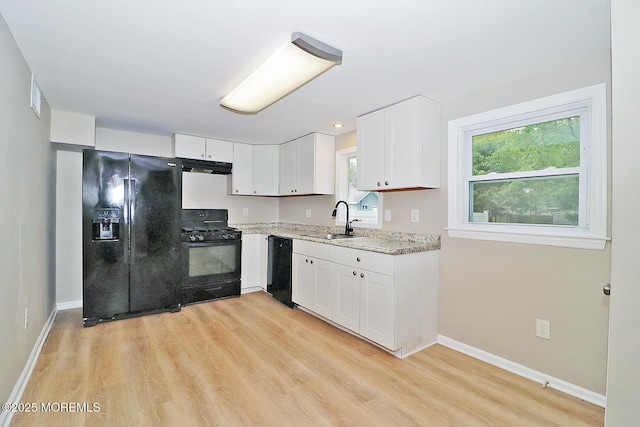 503 Center St, Forked River, NJ 08731 - kitchen featuring black appliances, a sink, under cabinet range hood, and light wood finished floors