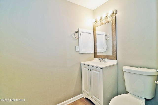 503 Center St, Forked River, NJ 08731 - half bath with vanity, toilet, baseboards, and wood finished floors