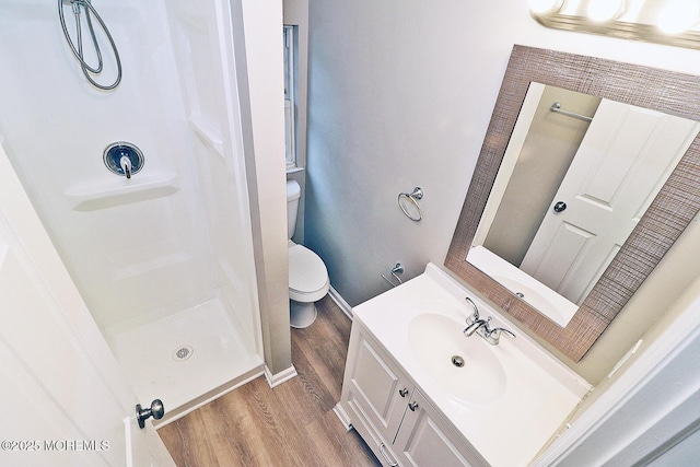 503 Center St, Forked River, NJ 08731 - bathroom featuring toilet, wood finished floors, vanity, a shower, and baseboards