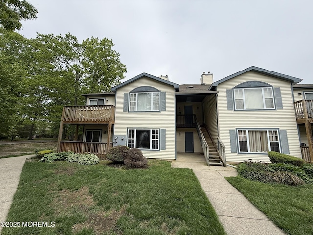 87 Puffin Glade, Berkeley, NJ 08721 - townhome / multi-family property with stairs, a front lawn, and a chimney
