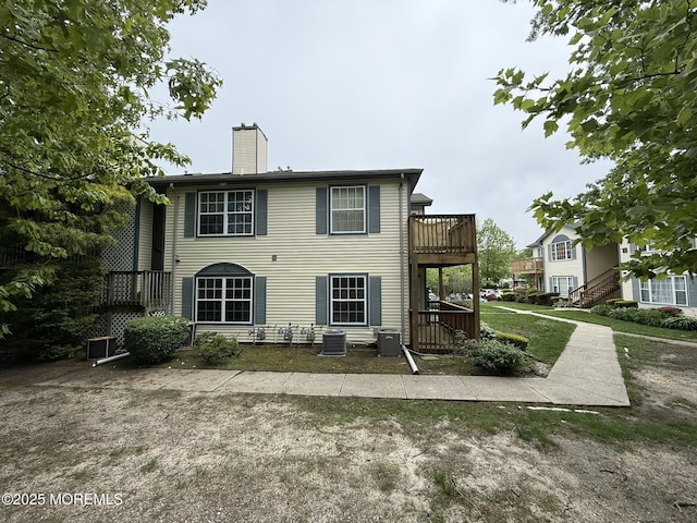 87 Puffin Glade, Berkeley, NJ 08721 - back of house featuring a chimney, a wooden deck, and central AC