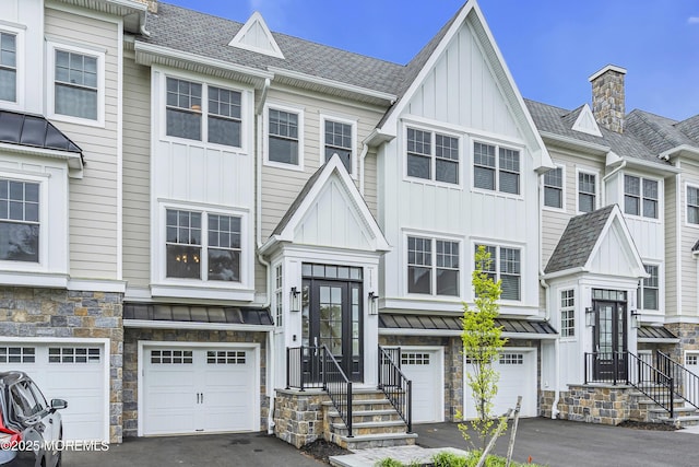 111 Eagle Way, Eatontown, NJ 07724 - multi unit property featuring board and batten siding, a standing seam roof, stone siding, and driveway