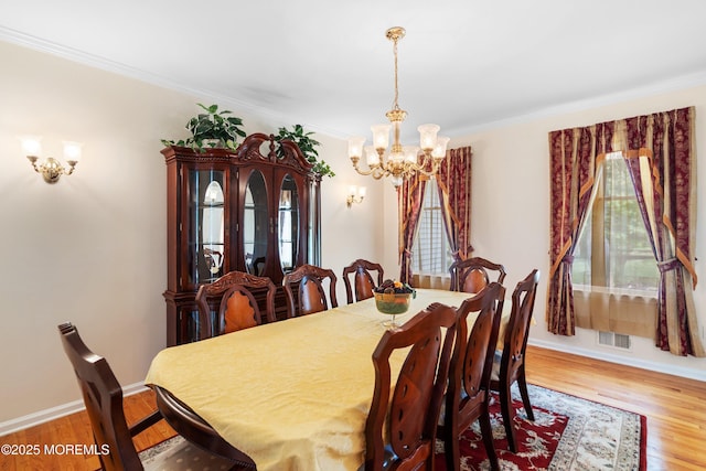 2 Kyle Ct, Jackson, NJ 08527 - dining area with a chandelier, wood finished floors, crown molding, and baseboards