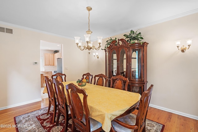 2 Kyle Ct, Jackson, NJ 08527 - dining room with a chandelier, light wood-style floors, ornamental molding, and baseboards