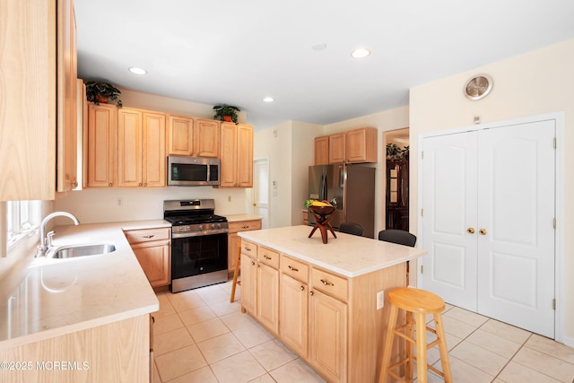 2 Kyle Ct, Jackson, NJ 08527 - kitchen with stainless steel appliances, a sink, light brown cabinets, light tile patterned floors, and a breakfast bar area