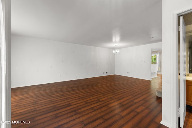 238 Larchwood Ct, Howell, NJ 07731 - unfurnished room with a chandelier, dark wood finished floors, and baseboards