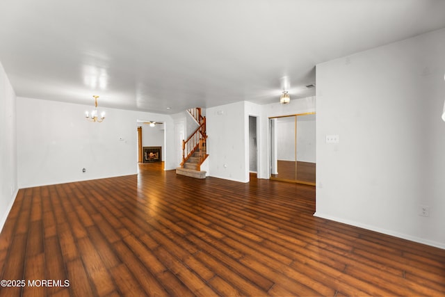 238 Larchwood Ct, Howell, NJ 07731 - unfurnished living room with stairway, wood finished floors, a chandelier, and baseboards