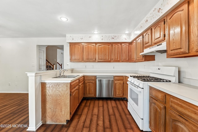 238 Larchwood Ct, Howell, NJ 07731 - kitchen featuring stainless steel dishwasher, white range with gas cooktop, under cabinet range hood, a sink, and dark wood finished floors