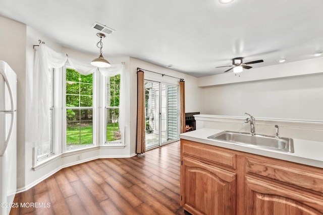 238 Larchwood Ct, Howell, NJ 07731 - kitchen featuring a sink, wood finished floors, a ceiling fan, freestanding refrigerator, and light countertops