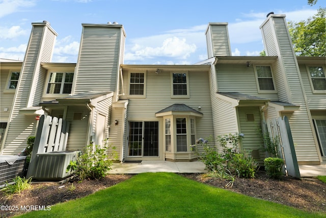 238 Larchwood Ct, Howell, NJ 07731 - back of house with central AC unit, a patio area, a chimney, and a yard