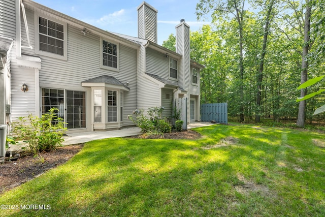 238 Larchwood Ct, Howell, NJ 07731 - rear view of house with a chimney and a yard