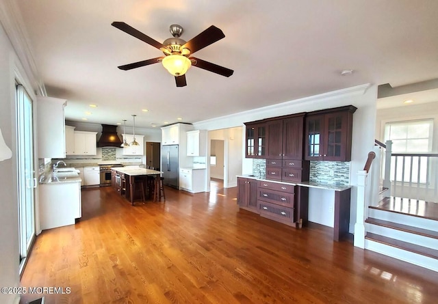 443 Driveway, Oceanport, NJ 07757 - kitchen with premium appliances, custom range hood, a sink, light countertops, and decorative backsplash