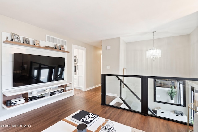 4 Wisteria Pl, Howell, NJ 07731 - living area with a chandelier, wood finished floors, and baseboards